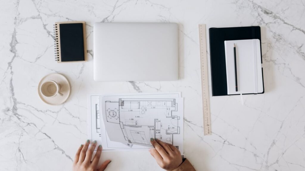 Planning a maintenance checklist at a desk with a laptop and notebook