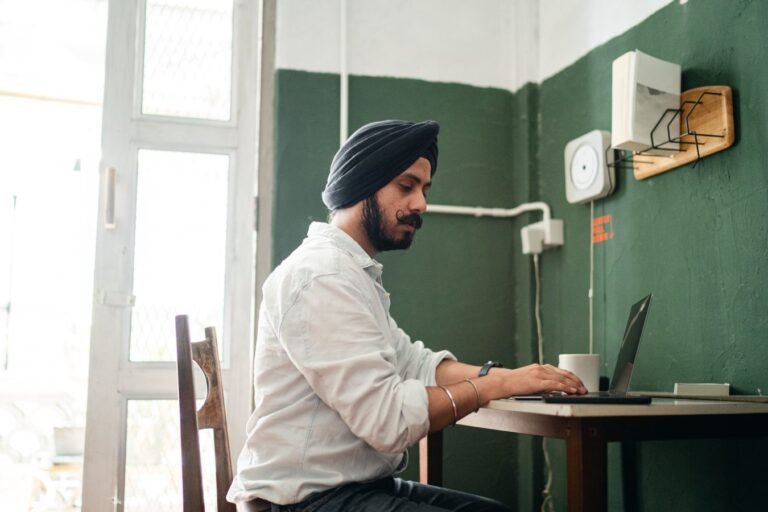 Indian business owner reviewing a website on a laptop