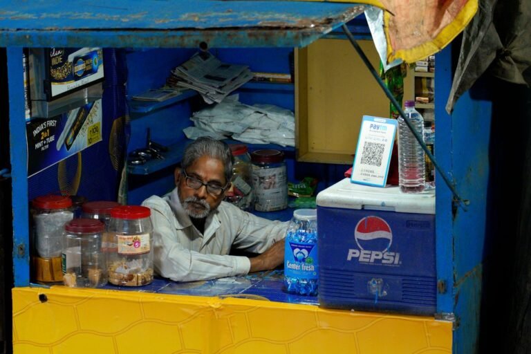 Indian local shop owner at his business