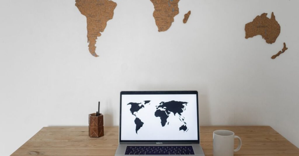 World maps displayed above and on a laptop for international planning